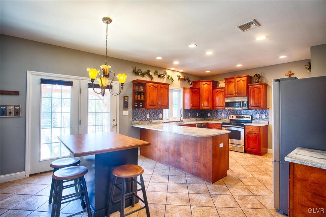 207 Bushkill Terrace Nazareth, PA 18064 - Photo 5 of 25 a open kitchen with stainless steel appliances granite countertop a stove and refrigerator