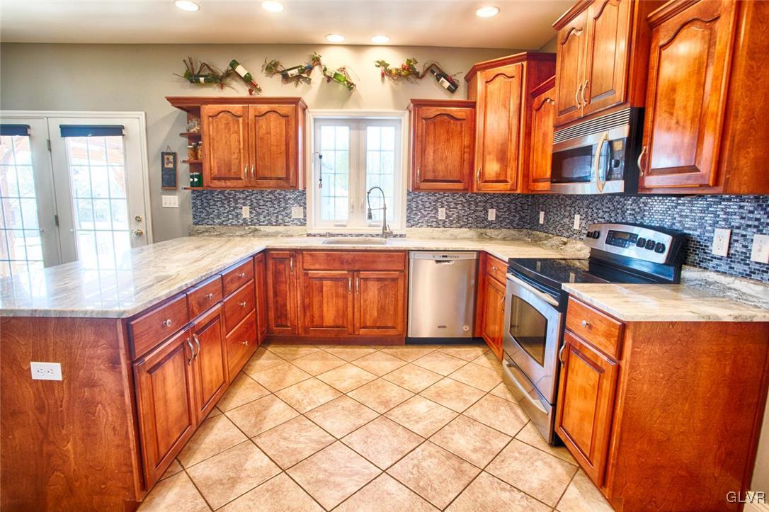 207 Bushkill Terrace Nazareth, PA 18064 - Photo 7 of 25 a kitchen with stainless steel appliances granite countertop a sink and cabinets