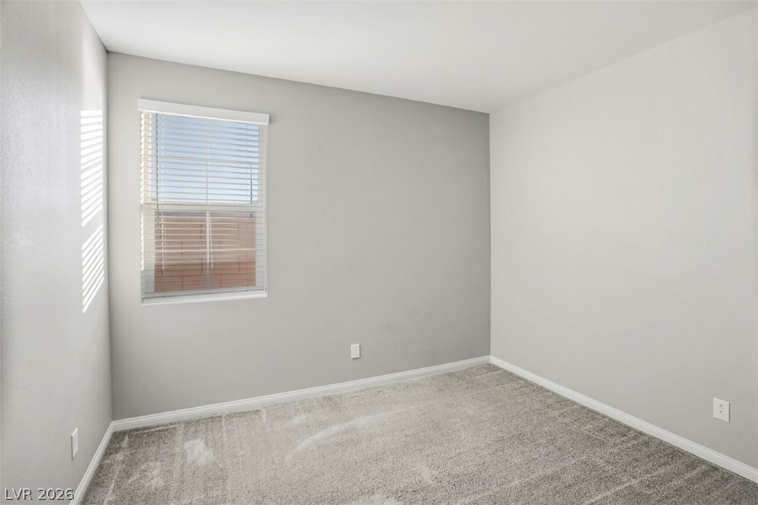 2865 Mincio Street Henderson, NV 89044 - Photo 3 of 33 Carpeted empty room with baseboards