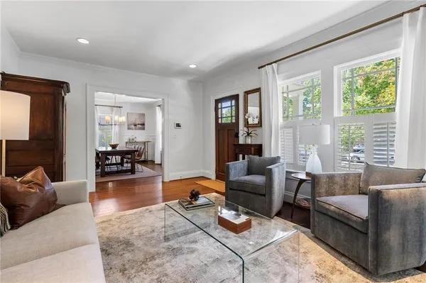 a kitchen with stainless steel appliances kitchen island granite countertop a stove top oven a sink a dining table and chairs
