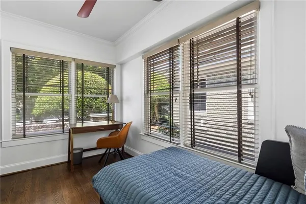 a kitchen with stainless steel appliances granite countertop a stove a refrigerator a sink a dining table and chairs with wooden floor