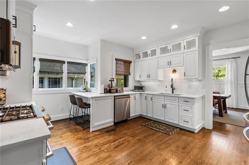 663 Yorkshire Road Northeast Atlanta, GA 30306 - Photo 25 of 85 a kitchen with sink cabinets and wooden floor