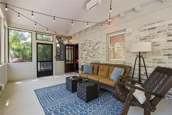 a kitchen with stainless steel appliances granite countertop a stove top oven a sink dishwasher and white cabinets with wooden floor