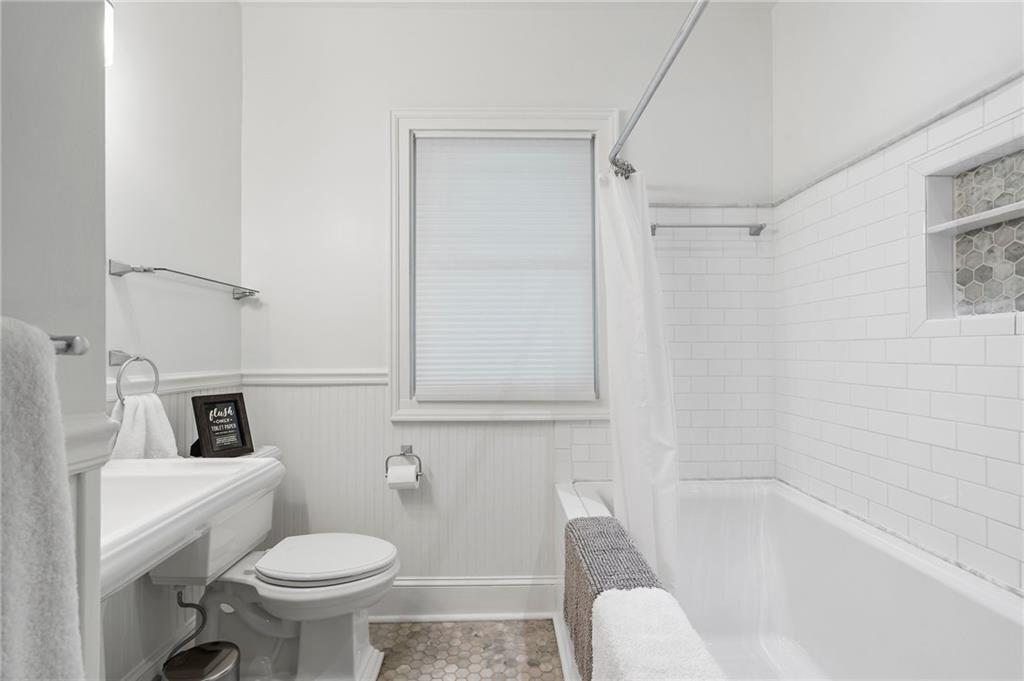 663 Yorkshire Road Northeast Atlanta, GA 30306 - Photo 36 of 85 a white toilet sitting next to a bath tub