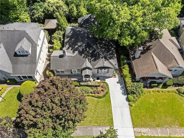 an aerial view of a house with swimming pool and garden