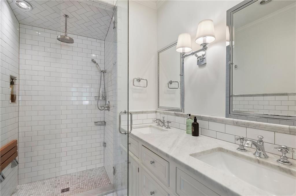 663 Yorkshire Road Northeast Atlanta, GA 30306 - Photo 47 of 85 a bathroom with a sink a double vanity and shower