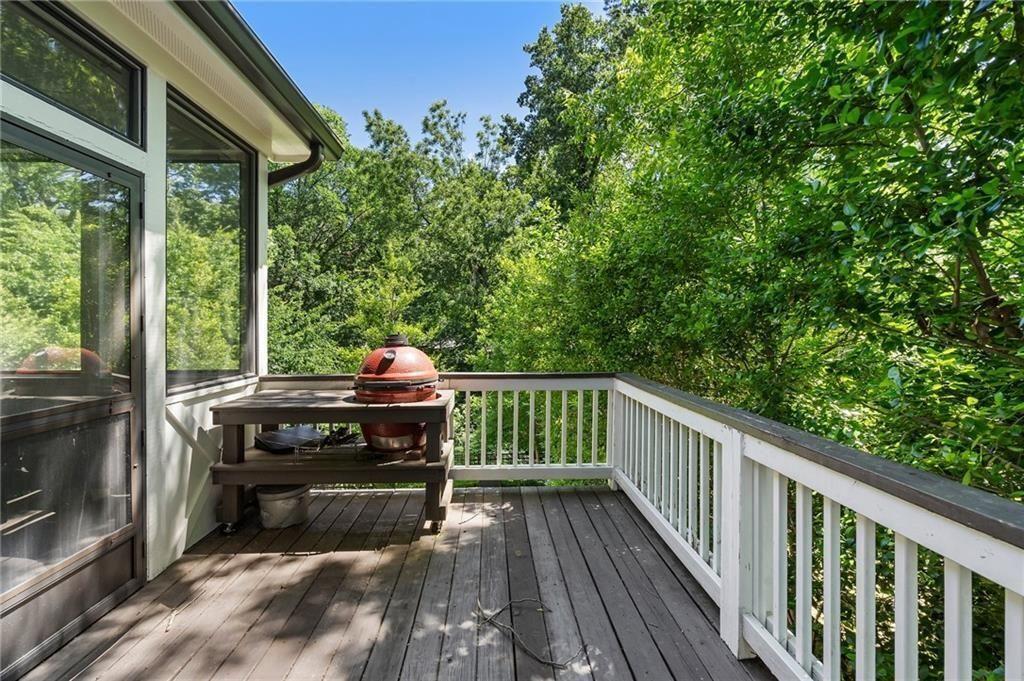 663 Yorkshire Road Northeast Atlanta, GA 30306 - Photo 49 of 85 a view of a deck with wooden floor barbeque oven and trees