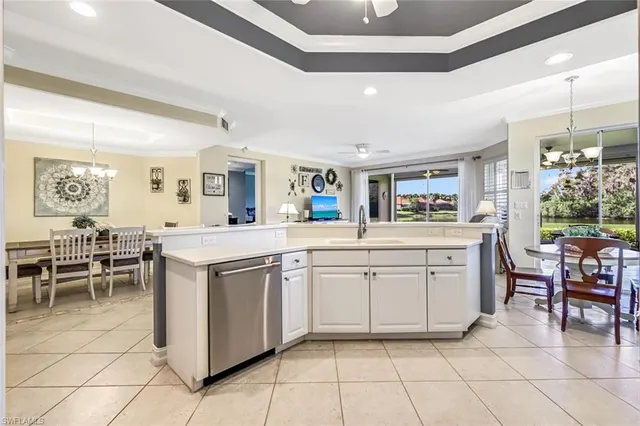 a kitchen with cabinets and chairs