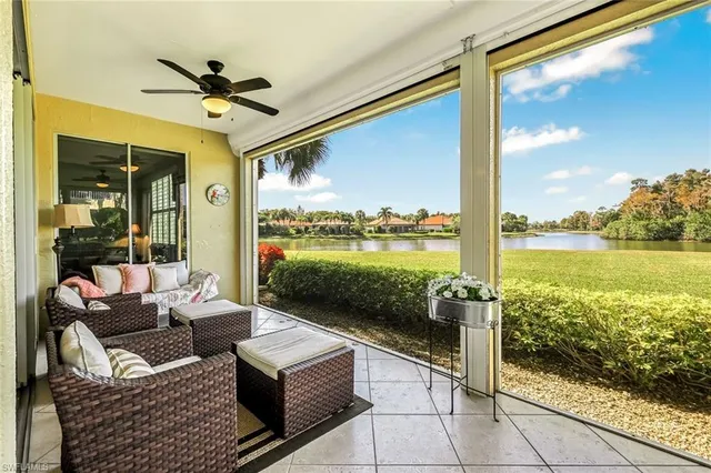 a balcony with furniture and a floor to ceiling window
