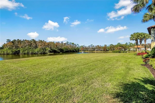 a view of a lake with houses in the background