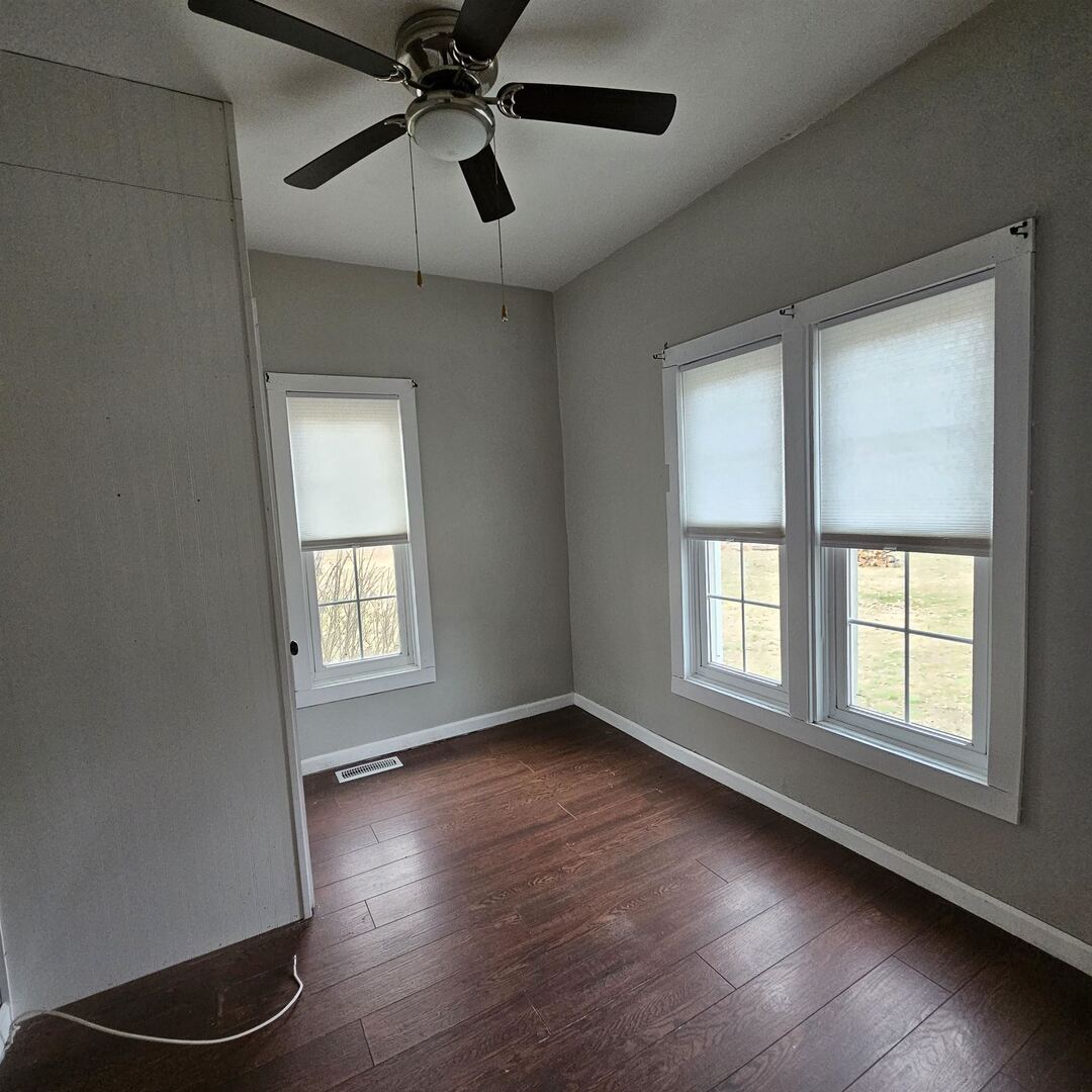 14027 North Link Lane Mount Vernon, IL 62864 - Photo 11 of 28 a view of an empty room with a window and wooden floor
