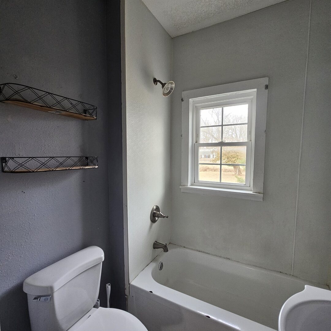 14027 North Link Lane Mount Vernon, IL 62864 - Photo 17 of 28 a white toilet sitting next to a bath tub