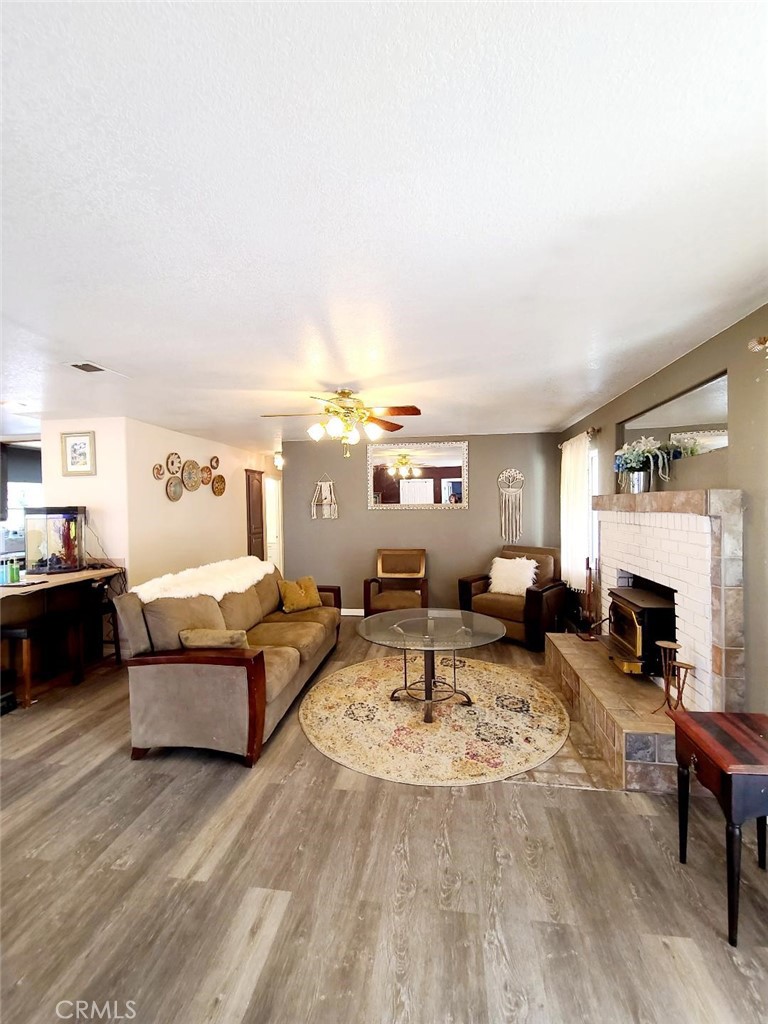 8725 Monte Vista Road Phelan, CA 92371 - Photo 11 of 31 a living room with furniture and a fireplace
