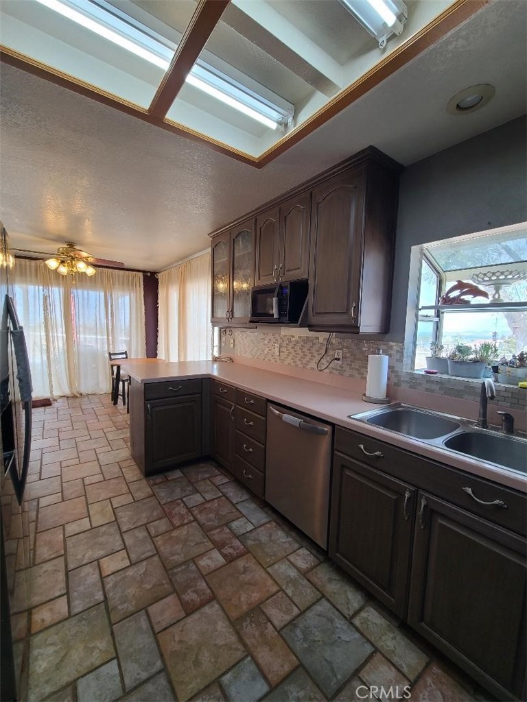8725 Monte Vista Road Phelan, CA 92371 - Photo 21 of 31 a kitchen with a sink cabinets and window