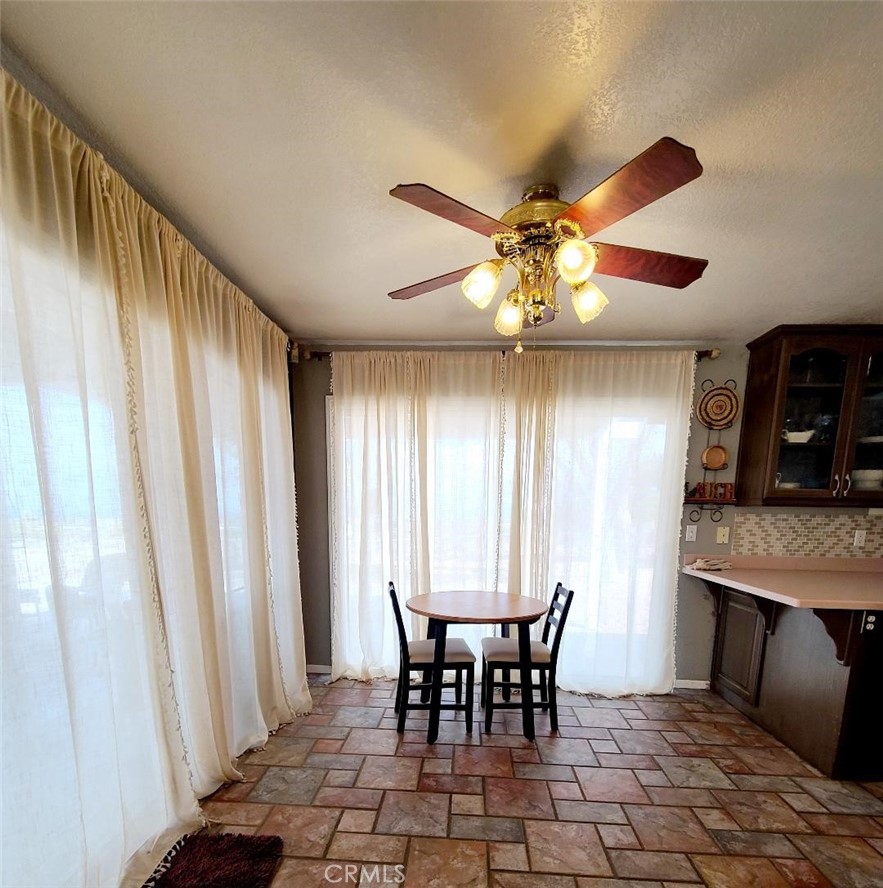 8725 Monte Vista Road Phelan, CA 92371 - Photo 22 of 31 a dining room with furniture and window