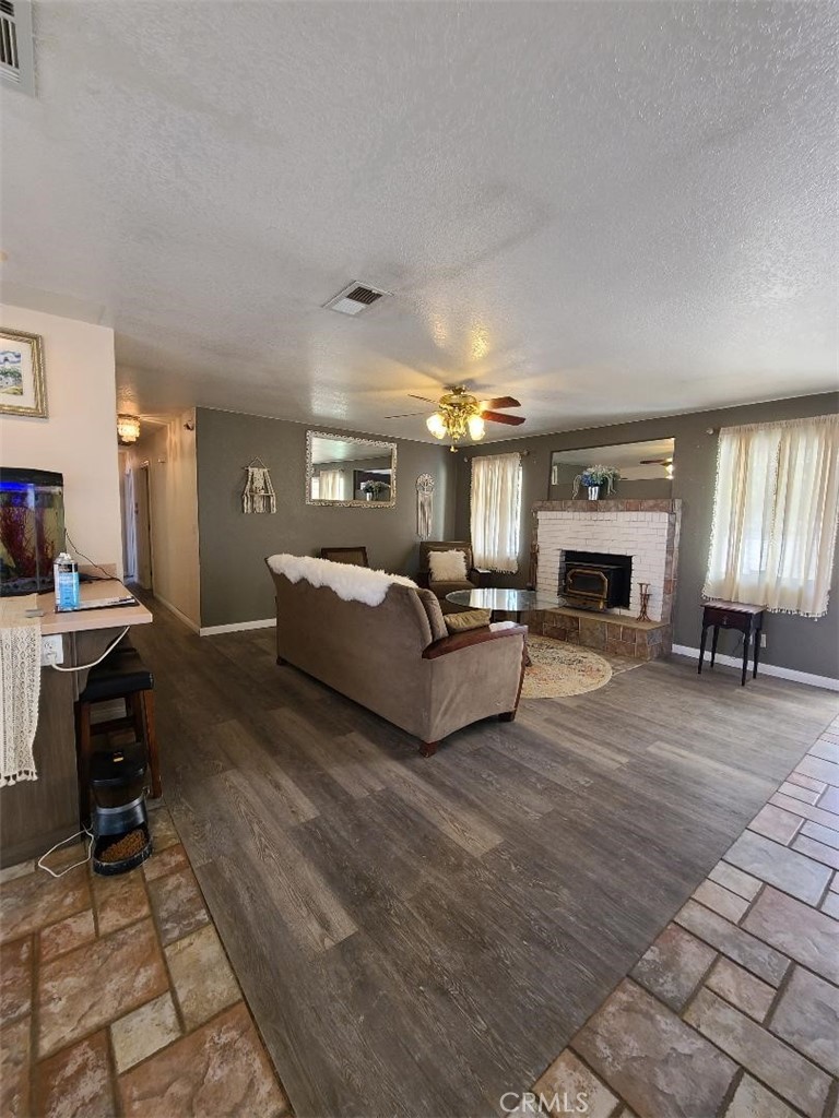 8725 Monte Vista Road Phelan, CA 92371 - Photo 23 of 31 a living room with furniture and a fireplace
