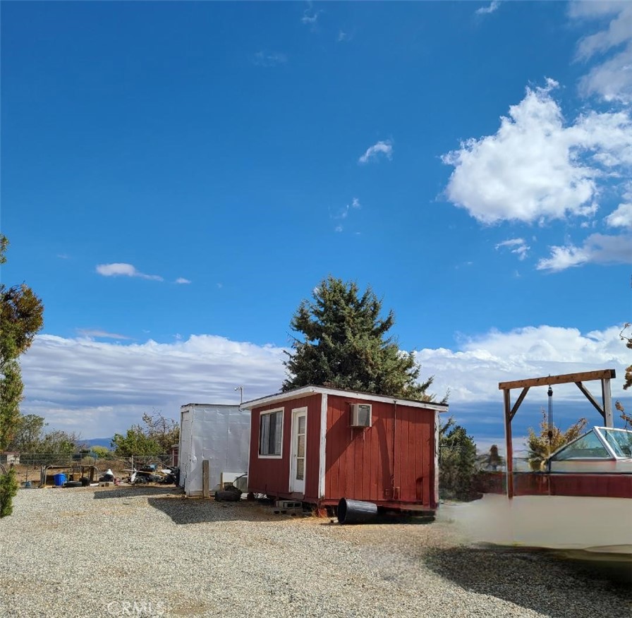 8725 Monte Vista Road Phelan, CA 92371 - Photo 29 of 31 a view of a house with backyard and sitting area