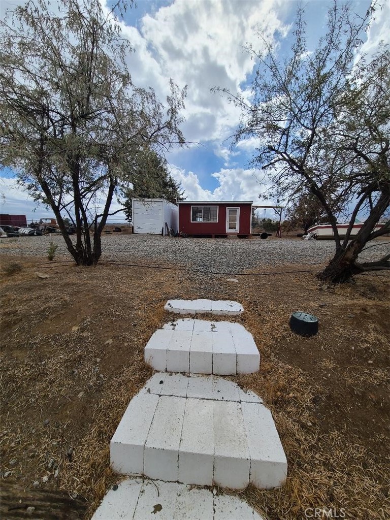 8725 Monte Vista Road Phelan, CA 92371 - Photo 7 of 31 a view of a house with a yard