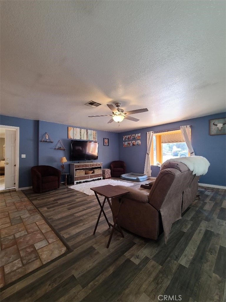 8725 Monte Vista Road Phelan, CA 92371 - Photo 9 of 31 a living room with furniture and a flat screen tv