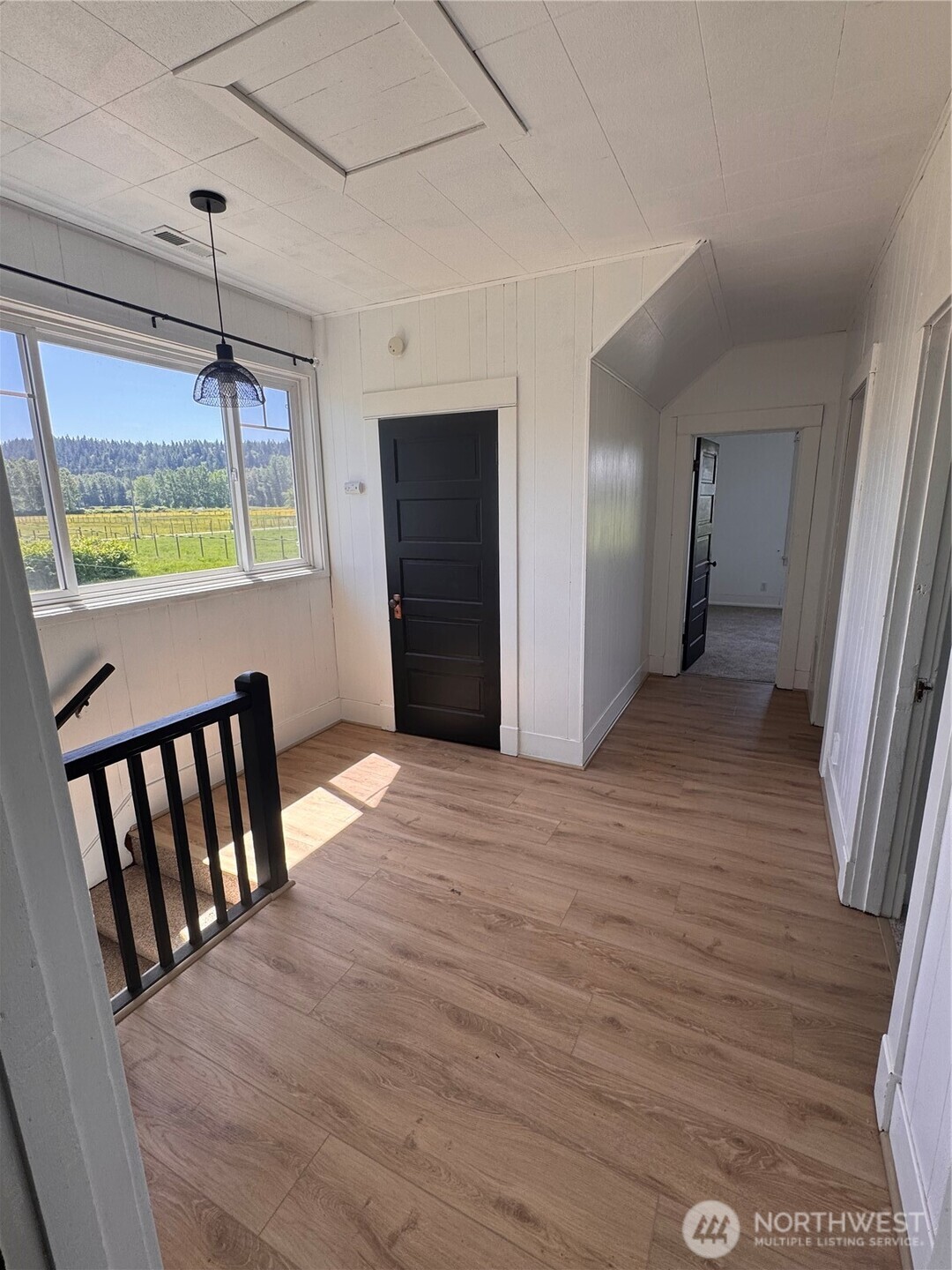 20016 Orville Road East Orting, WA 98360 - Photo 16 of 18 a view of an empty room with a window and hardwood floor