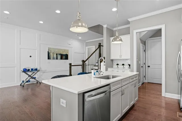 a kitchen with sink and mirror