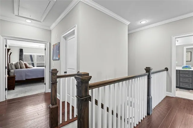 a view of a bedroom with wooden floor and furniture