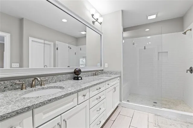 a bathroom with a granite countertop sink mirror and double