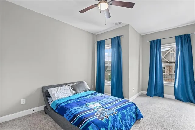 a bedroom with a large bed and a chandelier