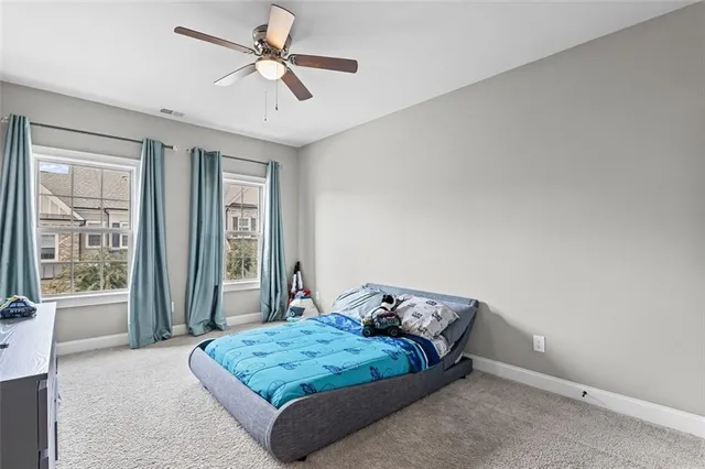 a bed sitting in a room next to a window