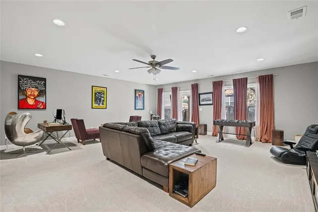 a living room with furniture a window and a flat screen tv