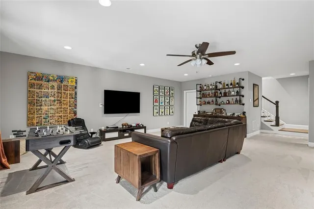 a living room with furniture kitchen view and a large window