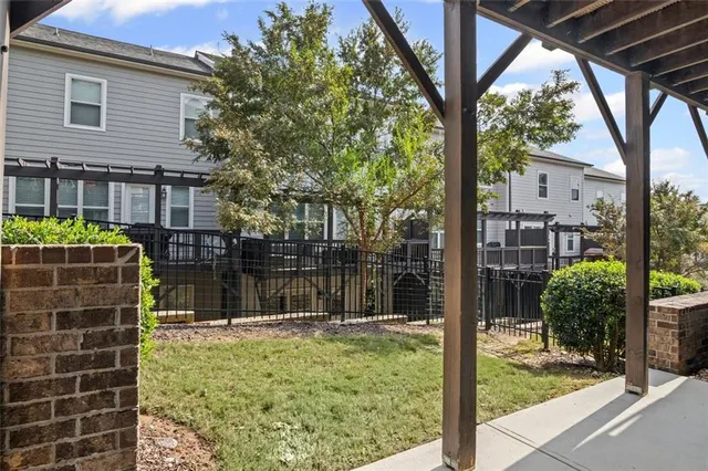 a backyard of a house with lots of green space and fountain