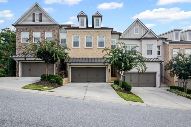 a front view of a house with yard and parking