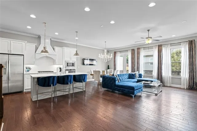 a living room with furniture or wooden floor and a large window