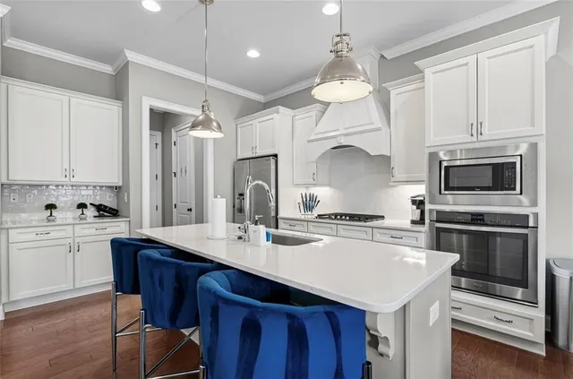 a kitchen with a sink a stove a microwave and cabinets