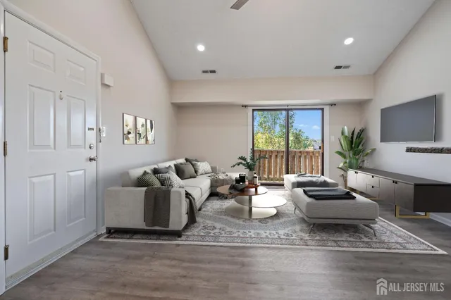 a living room with furniture and large windows