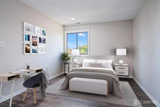 a bedroom with a bed and a desk