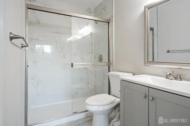 a bathroom with a sink toilet and shower