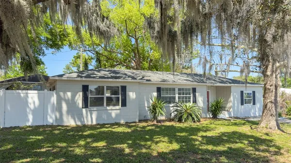 a view of a house with a yard and sitting area