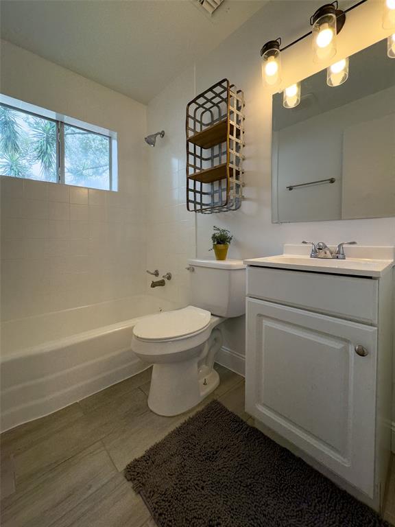 1047 Clay Boulevard Eustis, FL 32726 - Photo 12 of 33 a bathroom with a toilet sink and mirror