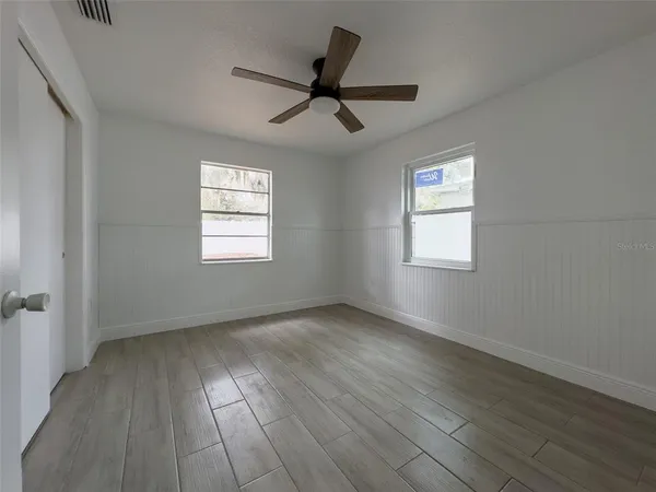wooden floor in an empty room with a window