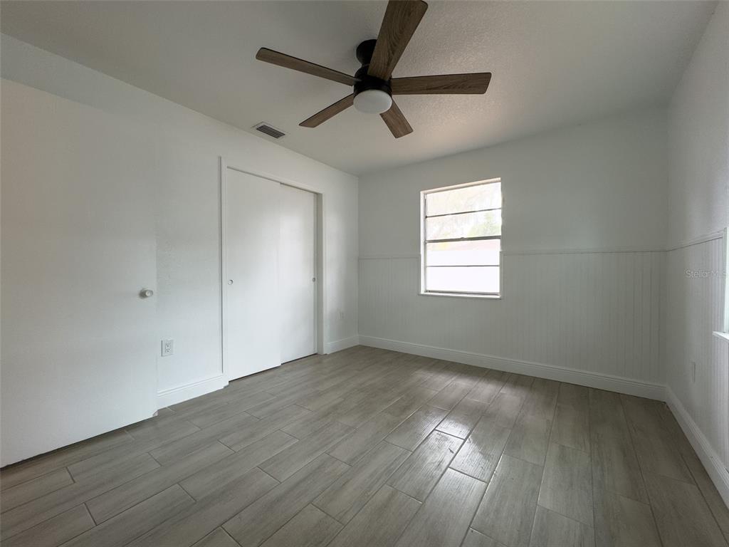 1047 Clay Boulevard Eustis, FL 32726 - Photo 16 of 33 wooden floor in an empty room with a window