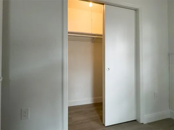 a view of an empty room and closet area