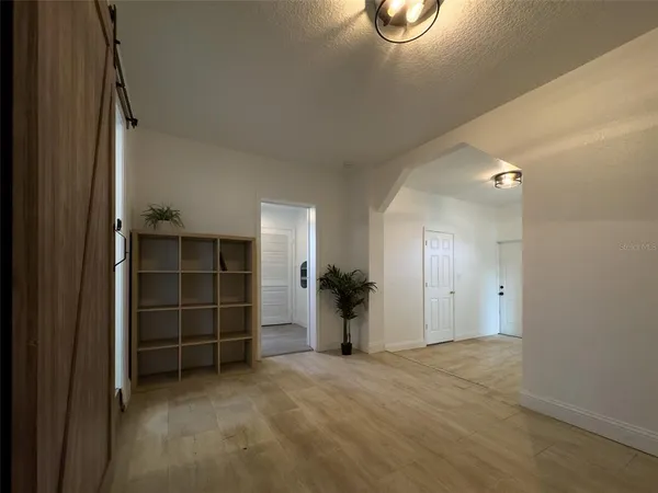 an empty room with furniture and a window