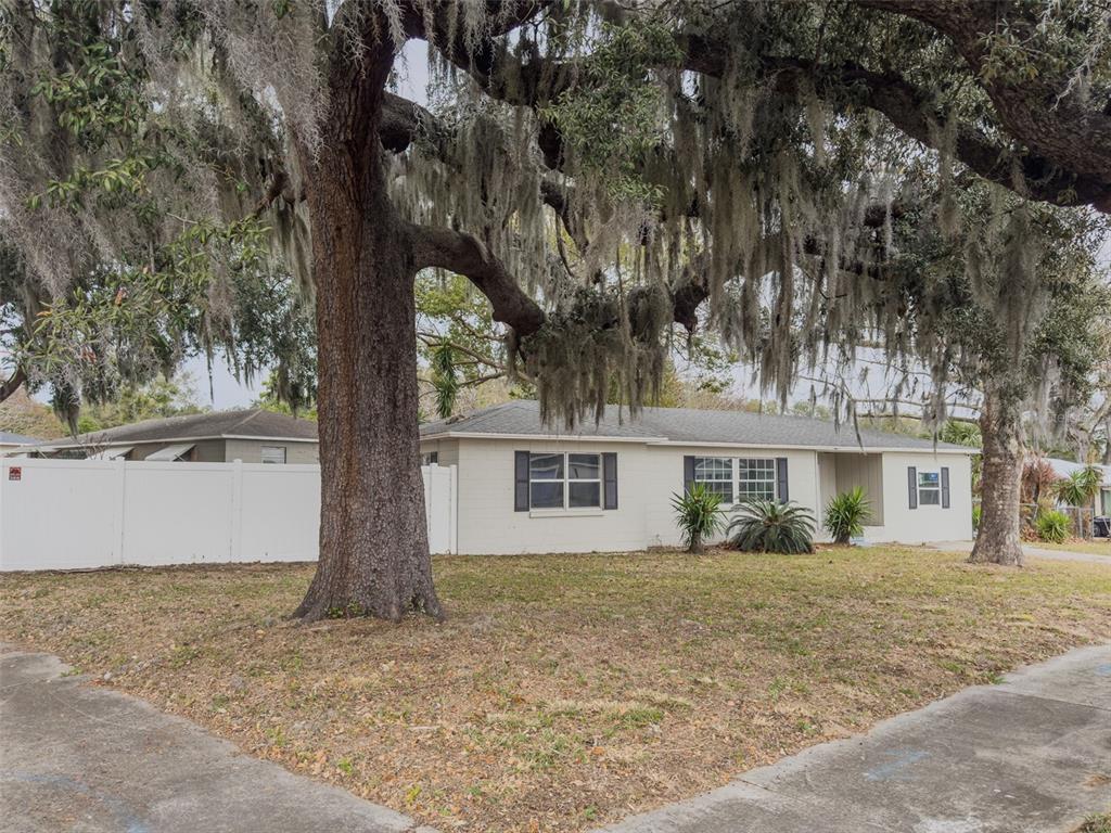 1047 Clay Boulevard Eustis, FL 32726 - Photo 2 of 33 front view of house with a trees