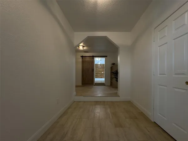 a view of a hallway with wooden shelves