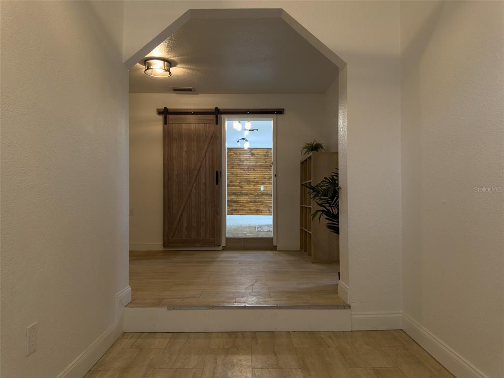 1047 Clay Boulevard Eustis, FL 32726 - Photo 22 of 33 a view of a hallway with wooden shelves