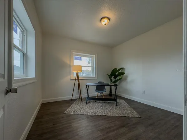 a view of a room with a table and chairs