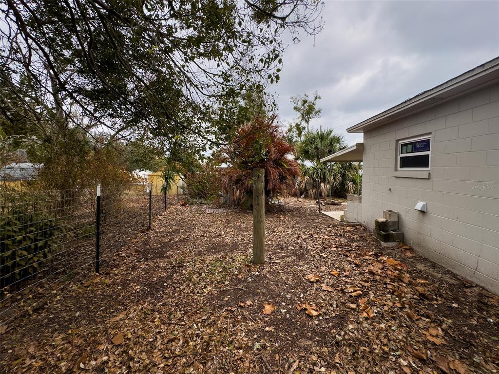 1047 Clay Boulevard Eustis, FL 32726 - Photo 30 of 33 a backyard of a house with lots of green space
