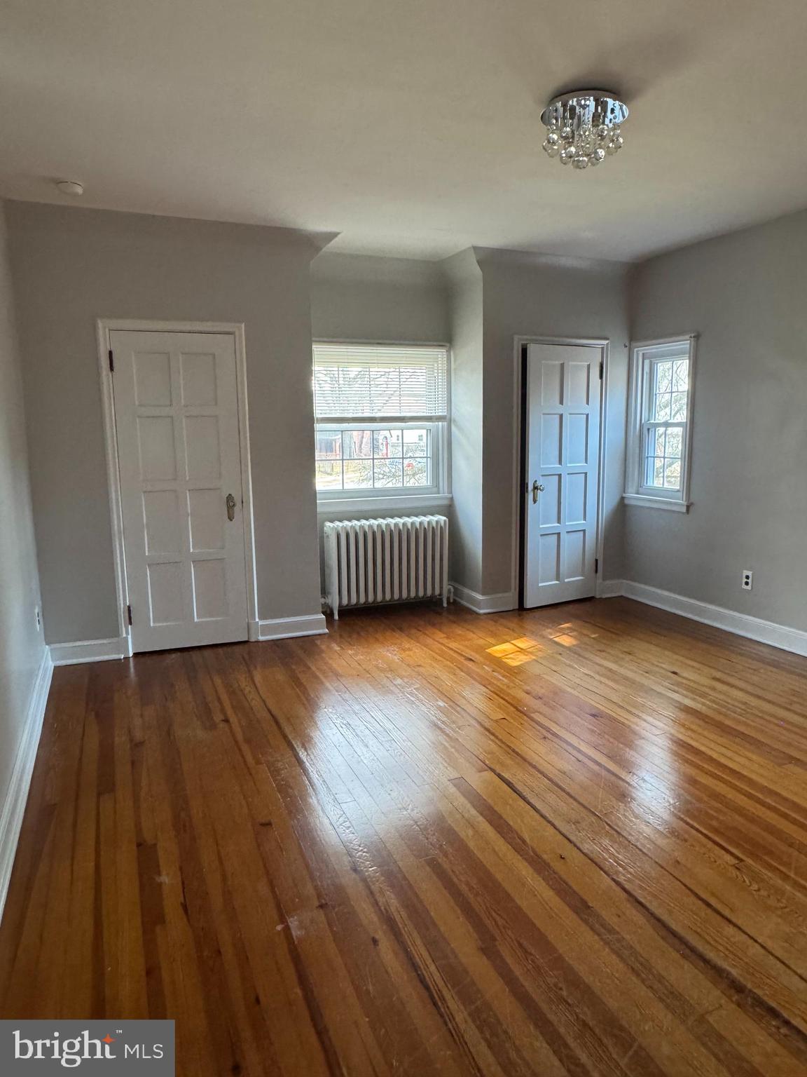 102 Harvard Boulevard Reading, PA 19609 - Photo 5 of 11 an empty room with wooden floor and windows
